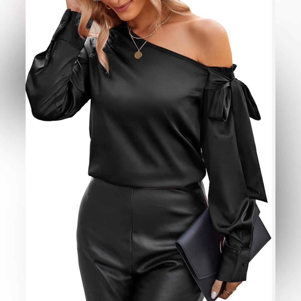 Off-shoulder black satin blouse. Long sleeve, cuffs w/buttons, rounded hem. M